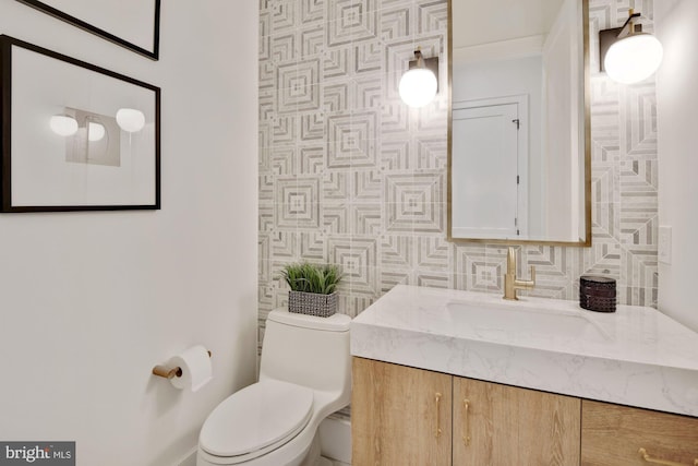 bathroom with vanity, toilet, tile walls, and backsplash