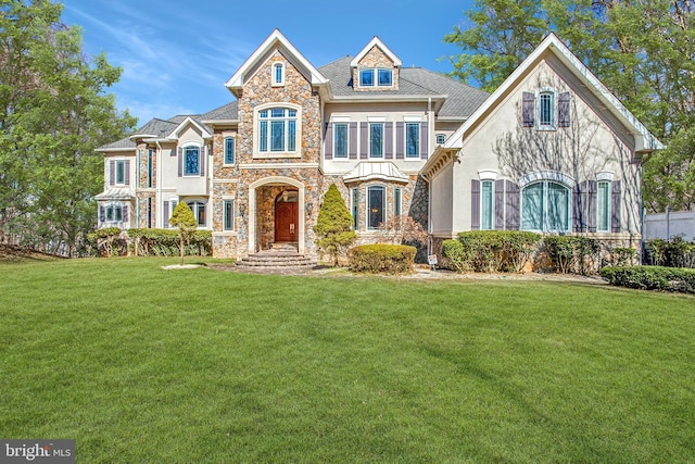 7024 Green Oak Dr, Mclean, VA 22101 - french country home with stone siding, a front yard, and stucco siding
