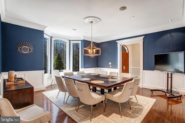 7024 Green Oak Dr, Mclean, VA 22101 - dining room with a decorative wall, crown molding, a chandelier, wood-type flooring, and wainscoting
