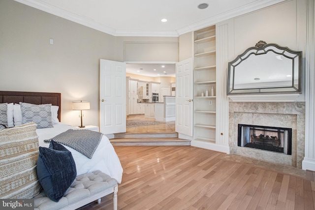 7024 Green Oak Dr, Mclean, VA 22101 - bedroom with light wood-style floors, ornamental molding, a fireplace, and recessed lighting