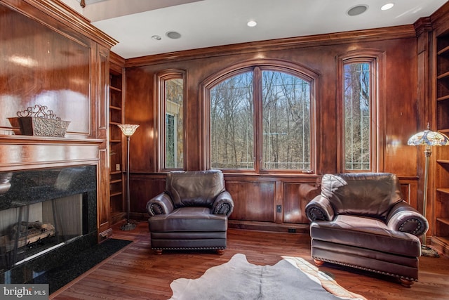 7024 Green Oak Dr, Mclean, VA 22101 - living area with healthy amount of natural light, a fireplace, built in features, wood finished floors, and crown molding