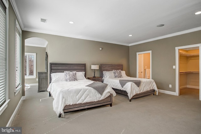 7024 Green Oak Dr, Mclean, VA 22101 - carpeted bedroom with ornamental molding, arched walkways, baseboards, recessed lighting, and a walk in closet