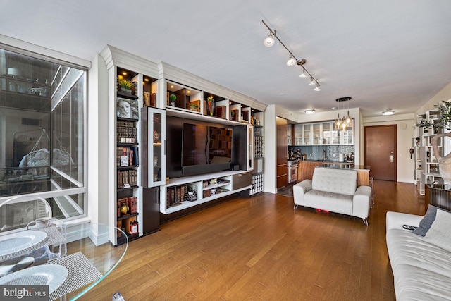 living room with hardwood / wood-style floors and a notable chandelier