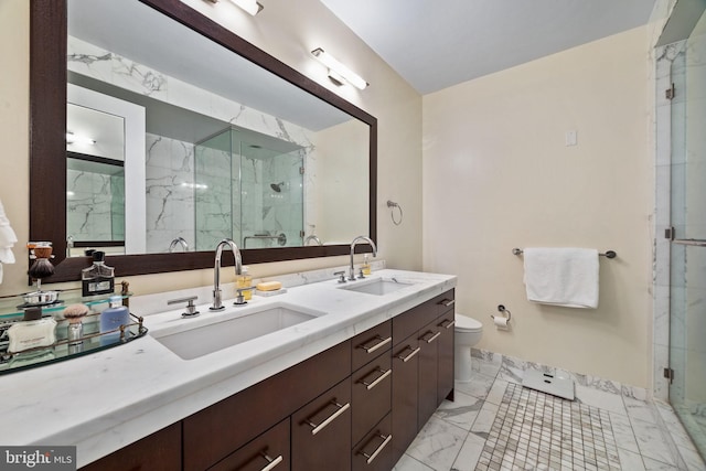 bathroom with a shower with door, vanity, and toilet