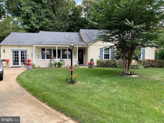 ranch-style home with a porch, a front lawn, and french doors