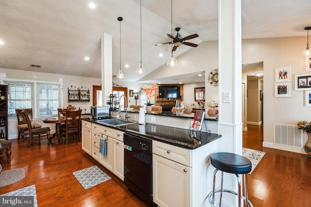 kitchen with visible vents, dishwasher, dark wood-style floors, open floor plan, and a sink