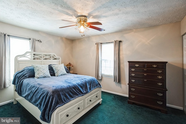 bedroom featuring multiple windows, baseboards, and dark colored carpet