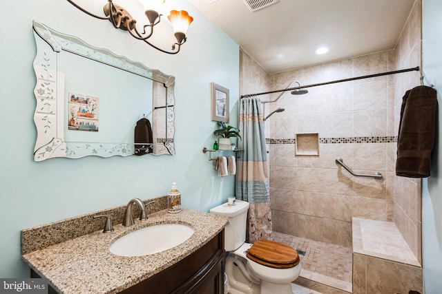 full bath featuring toilet, visible vents, a tile shower, and vanity