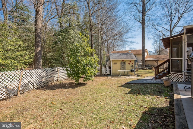 view of yard with entry steps, a sunroom, fence, and an outdoor structure