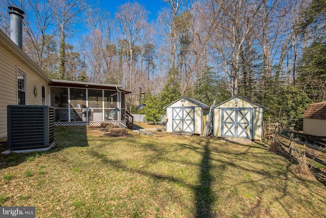 view of yard featuring a storage shed, fence, a sunroom, and cooling unit