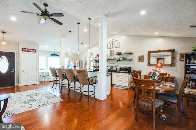 interior space with lofted ceiling, recessed lighting, dark wood-type flooring, ceiling fan, and a textured ceiling