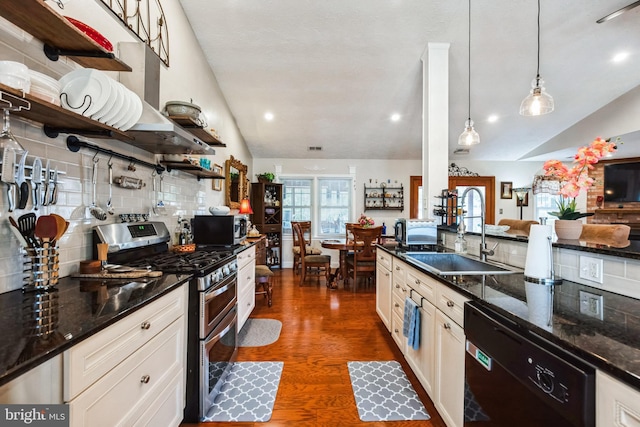 kitchen featuring open shelves, vaulted ceiling, stainless steel appliances, and a sink