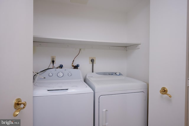 washroom with washing machine and clothes dryer