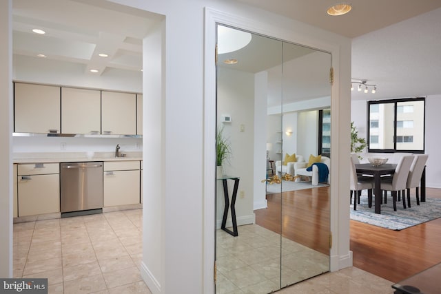 kitchen featuring sink, light tile patterned floors, and stainless steel dishwasher