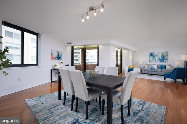 dining area featuring dark wood-type flooring