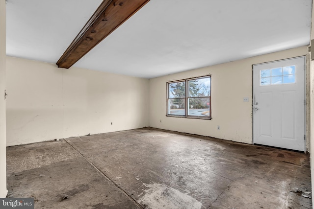 entryway featuring beam ceiling