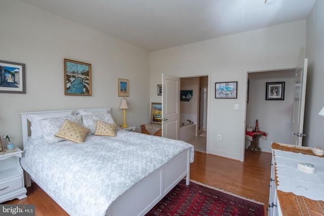 bedroom with dark hardwood / wood-style floors