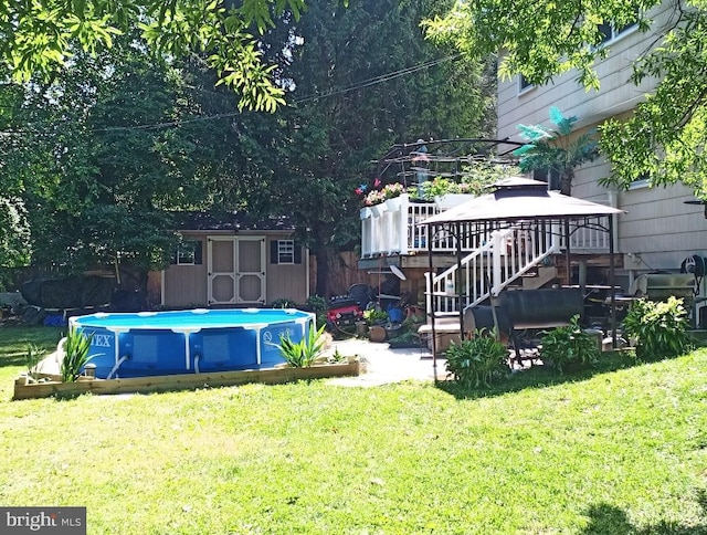 view of swimming pool with a gazebo, a yard, and a storage shed