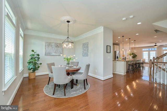 7916 Culloden Crest Ln, Gainesville, VA 20155 - dining area featuring wood finished floors, recessed lighting, a chandelier, stairs, and ornamental molding