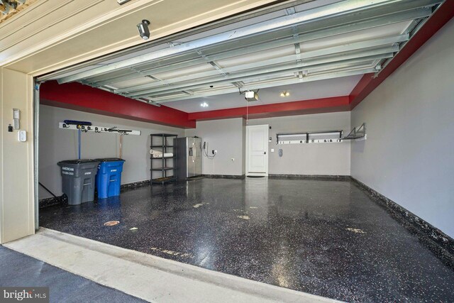 7916 Culloden Crest Ln, Gainesville, VA 20155 - garage with stainless steel refrigerator with ice dispenser and a garage door opener