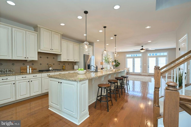 7916 Culloden Crest Ln, Gainesville, VA 20155 - kitchen featuring stainless steel appliances, recessed lighting, a ceiling fan, a spacious island, and light stone counters