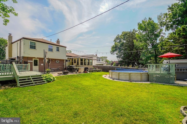 view of yard with a swimming pool side deck