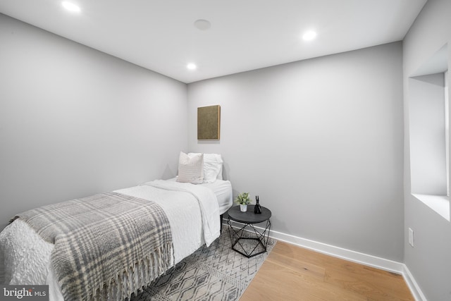 bedroom with hardwood / wood-style flooring