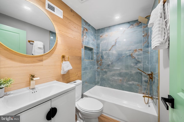 full bathroom featuring vanity, toilet, and tiled shower / bath combo