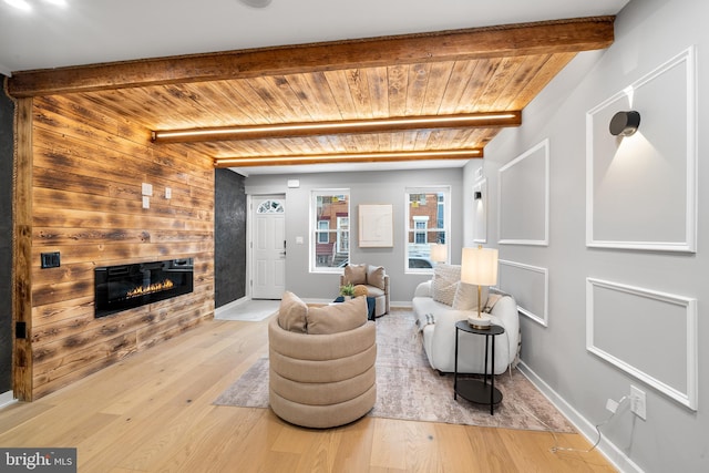 living room featuring hardwood / wood-style flooring, wooden ceiling, and beam ceiling