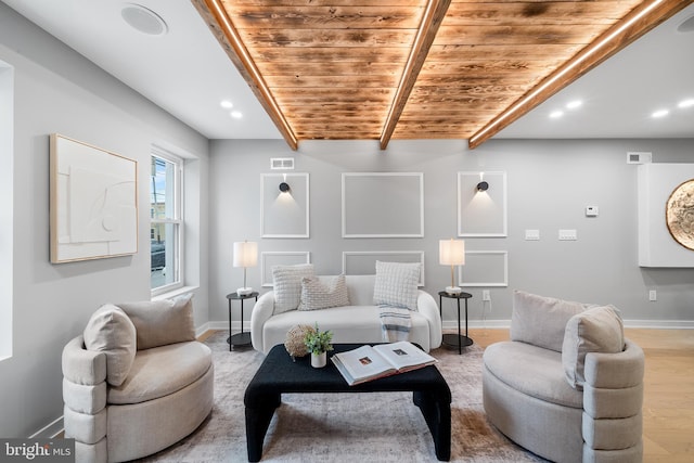 living room with light hardwood / wood-style floors and wooden ceiling