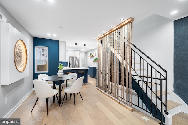 dining room with sink and light hardwood / wood-style floors