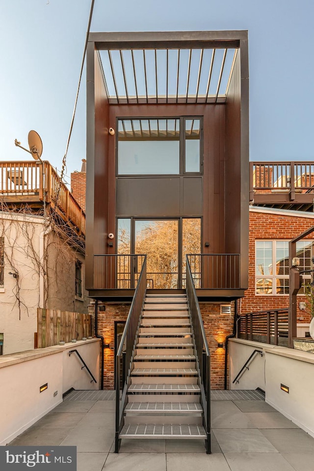 view of exterior entry featuring brick siding