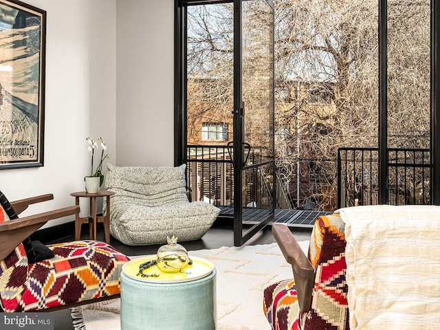 living area featuring baseboards