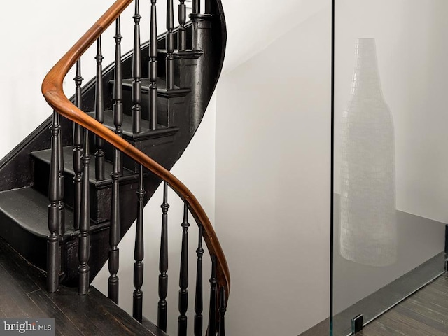 stairway featuring wood finished floors