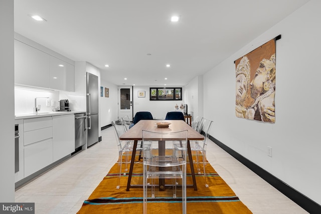 dining space featuring recessed lighting and baseboards