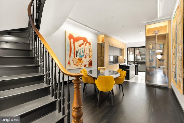 dining area with stairs and wood finished floors