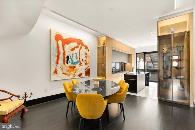 dining area featuring baseboards and wood finished floors