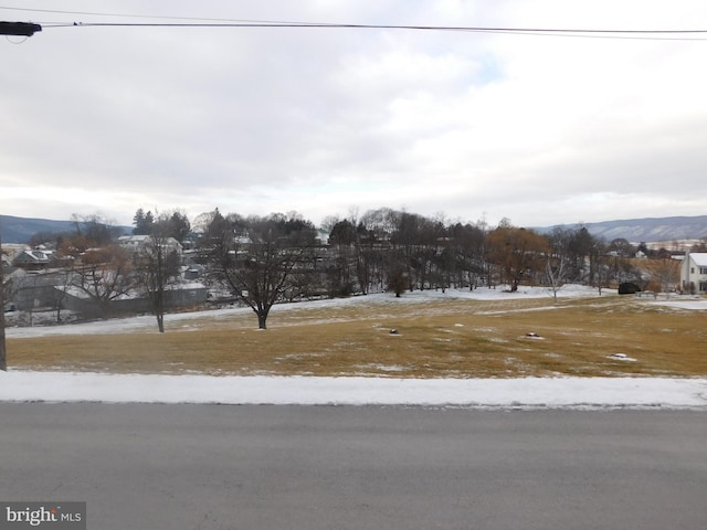 snowy yard featuring a mountain view