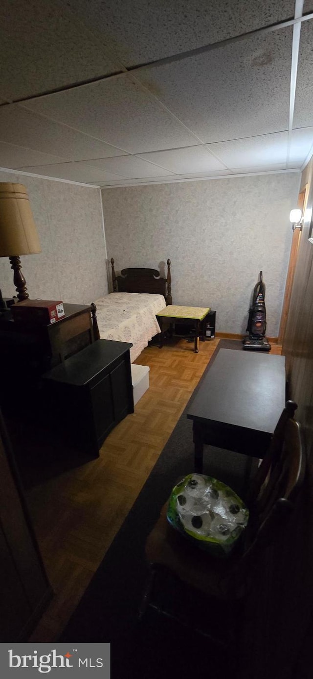 bedroom with parquet floors and a paneled ceiling