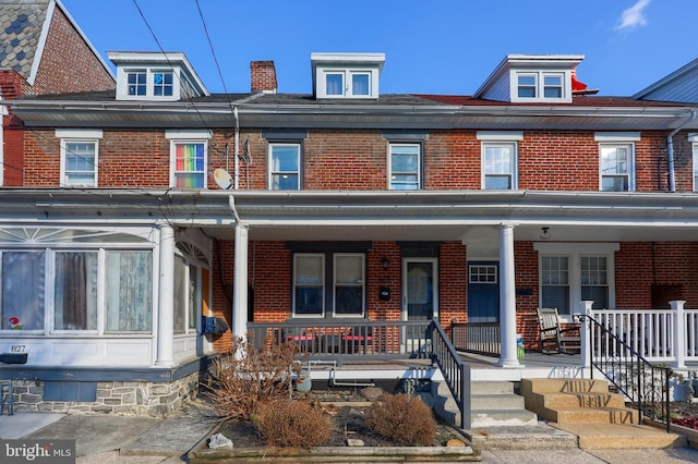 townhome / multi-family property featuring covered porch