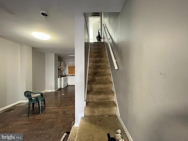 stairway with hardwood / wood-style flooring