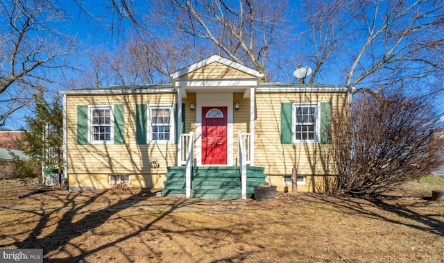 bungalow-style house with a front lawn