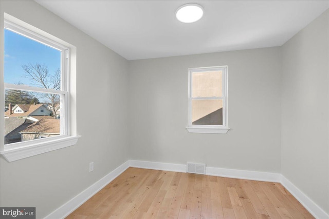 unfurnished room with a healthy amount of sunlight and light wood-type flooring