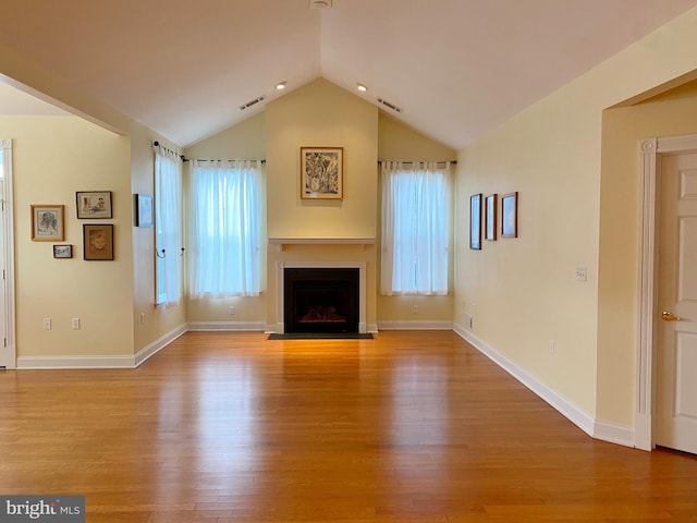 unfurnished living room with lofted ceiling and light hardwood / wood-style floors