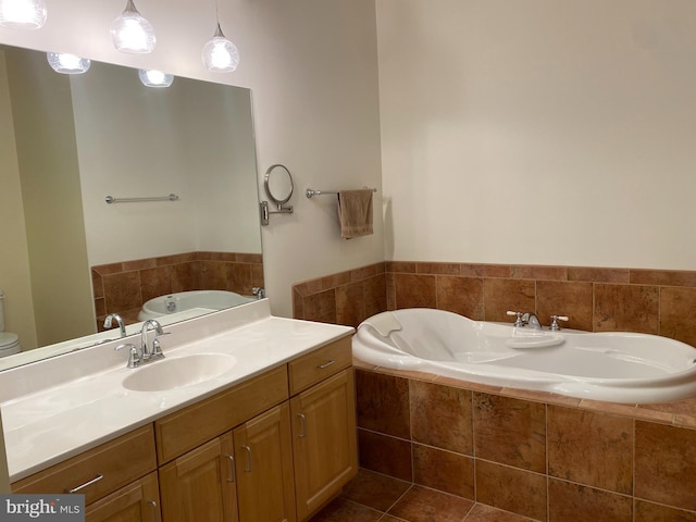 bathroom featuring a relaxing tiled tub, vanity, and toilet