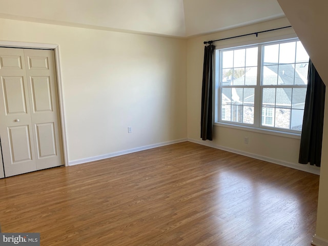 unfurnished bedroom featuring light hardwood / wood-style floors and a closet