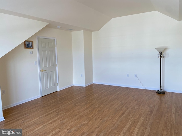 bonus room featuring wood-type flooring and vaulted ceiling