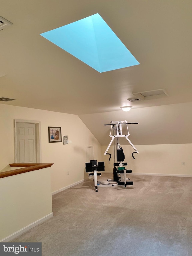 workout area featuring lofted ceiling and light carpet