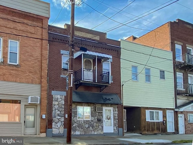 view of building exterior with a wall mounted air conditioner