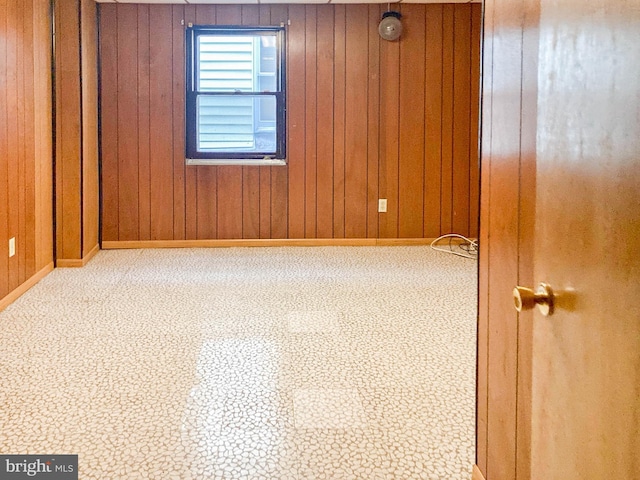 unfurnished room with wooden walls